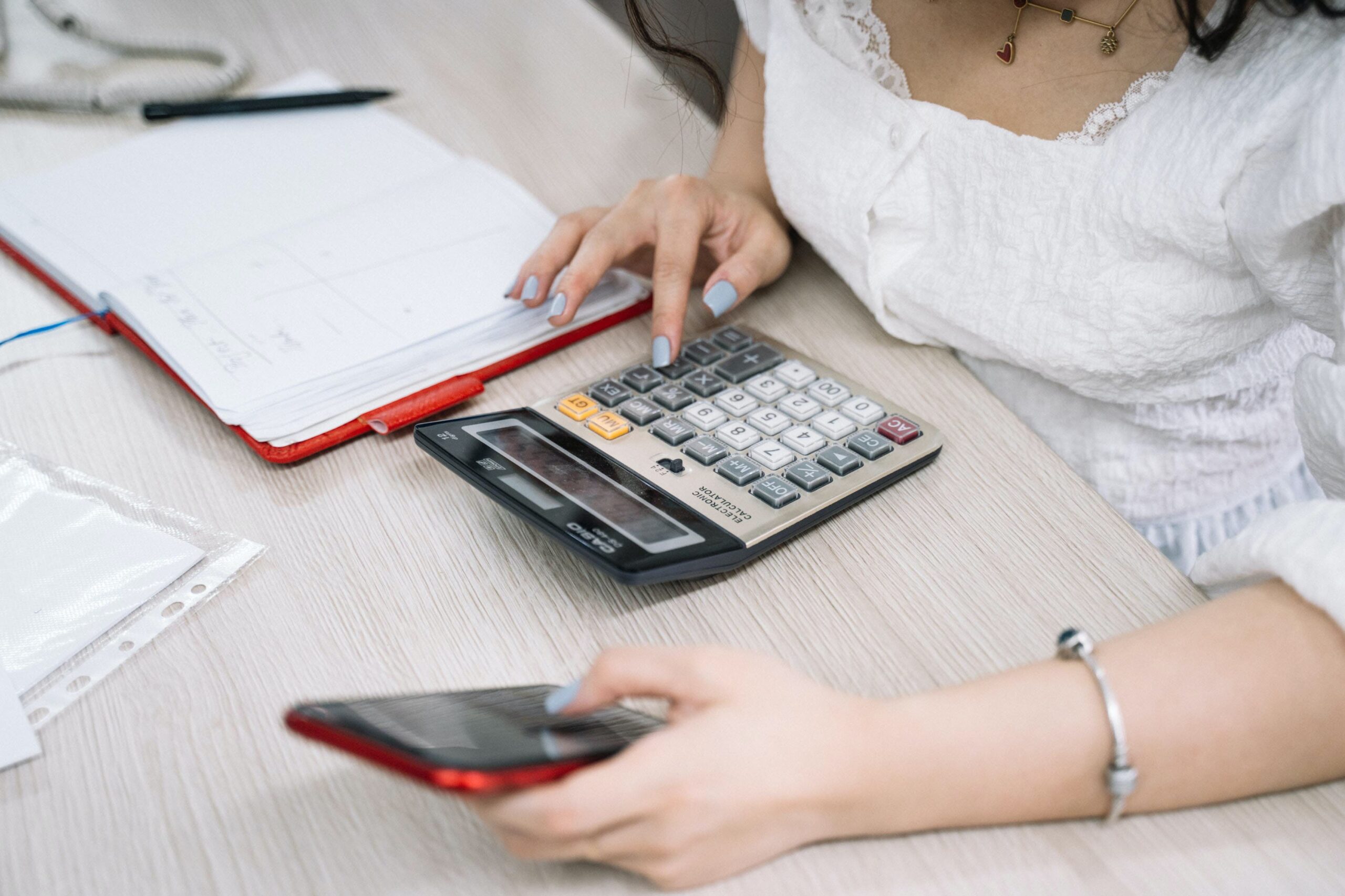 Woman using a calculator for some calculations